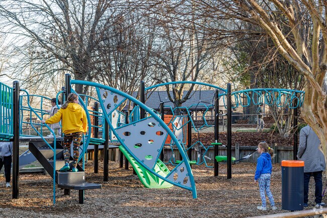 On a sunny afternoon, kids from Oak View relish the playground at High Point City Lake Park.