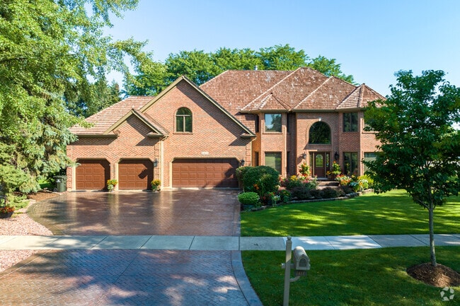 A beautiful Shingle style home with a multi-car garage is a popular home style in Meadow Glens.