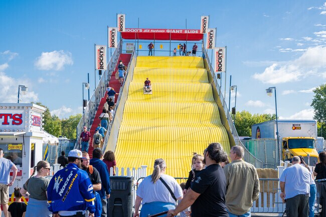 Folks ride the giant slide on burlap sacks at the Big E in West Springfield.