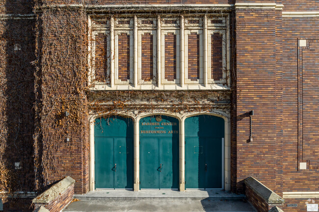 Three green doors sit at the top of concrete stairs at Rowland Hall.