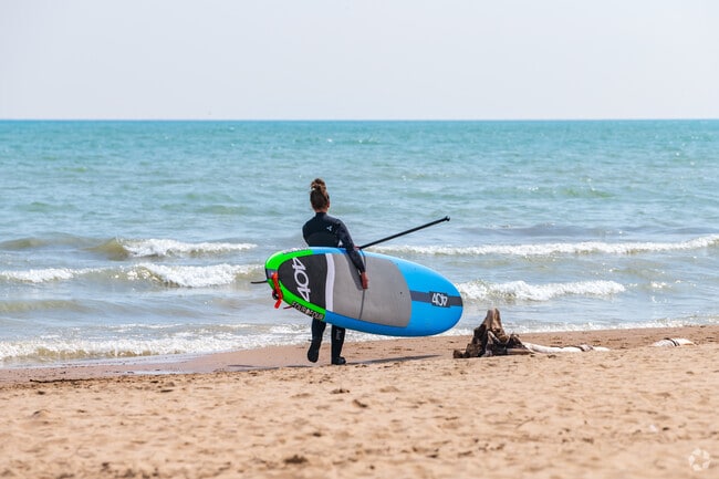 A Paddleboarder Headed Out into Lake Michigan