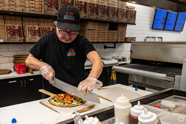 Fresh out of the oven a custom pizza is being sliced at Pizza n Brews in Whittier.