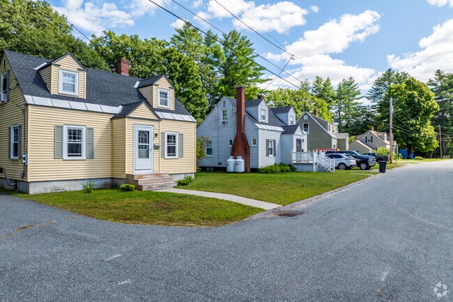 A row of cape-style homes in Maple Avenue District has short driveways and stone paths.