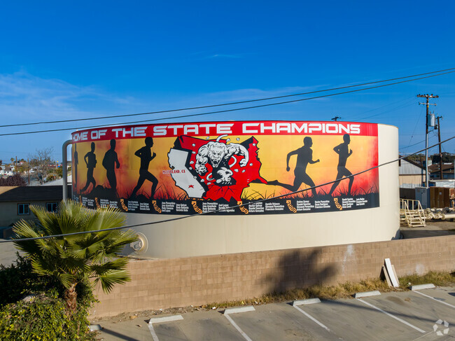 A large mural depicts the McFarland High School track team's many state championships.