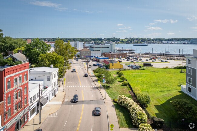 Downtown New London from above, showcasing the Thames River and passing ferries.