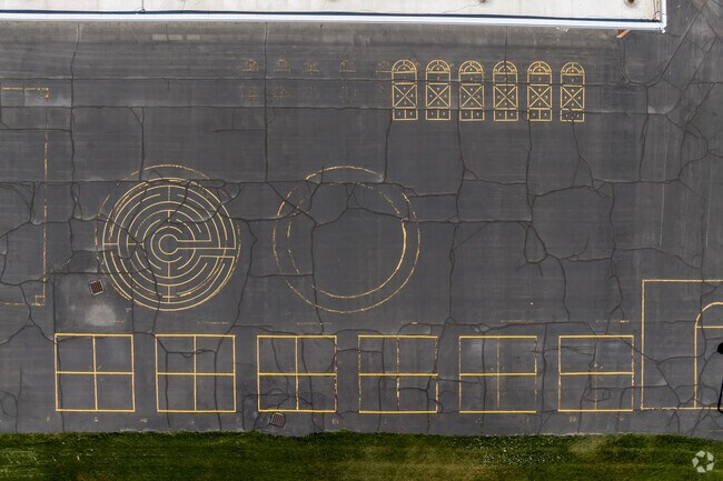 A blacktop play area at Grant Elementary has games painted in vibrant yellow.