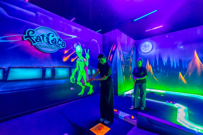 The glow-in-the-dark mini golf course at FatCats Queen Creek provides a unique and entertaining experience for visitors from Charleston Estates.