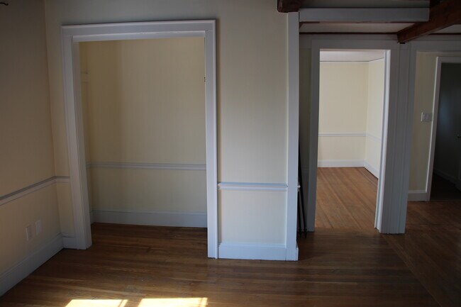 Living Room with closet to left and doorway to Dining Room on right