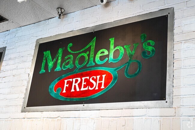 Magelby’s Fresh has a colorful sign with green and red against a black background.