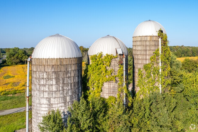 Travel by the silos that rest on Medford farmlands.