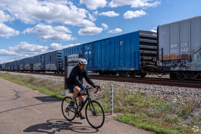 On a sunny day, a bicyclist takes in the scenic views along the County Line Trail in Rittman.