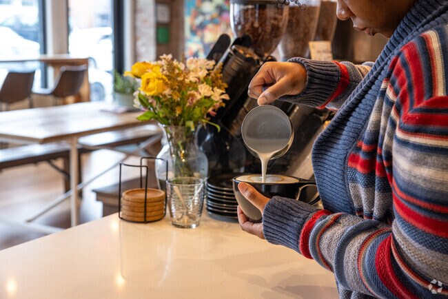 Latte art is carefully constructed at the famous Queen City Coffee Roasters in Plainfield.
