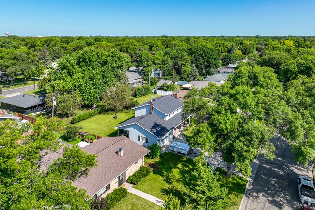 View of Longfellow neighborhood showing the homes surrounded by lush green trees and grass.