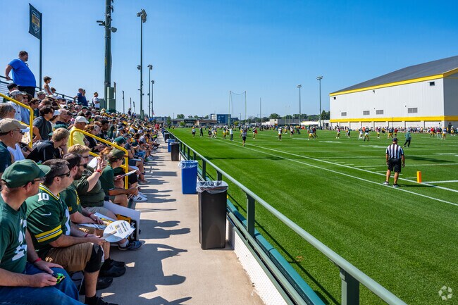 Fans sitting front row at Packers training camp.