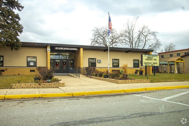Saint John Bosco School features a yellow brick design.