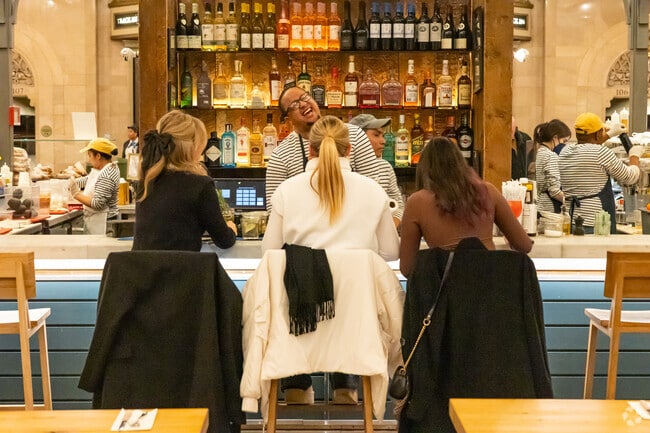 Commuters have a drink and laugh before heading home from Grand Central Station in Midtown East.