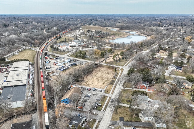 A train runs through the lovely town of Elm Grove.