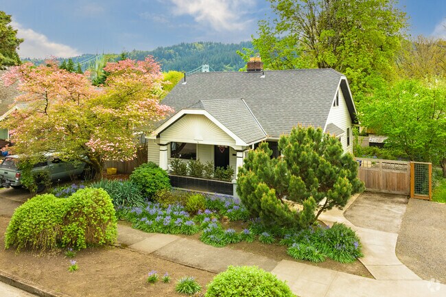The St. Johns Bridge peaks over this craftsman bungalow in the Cathedral Park Neighborhood.