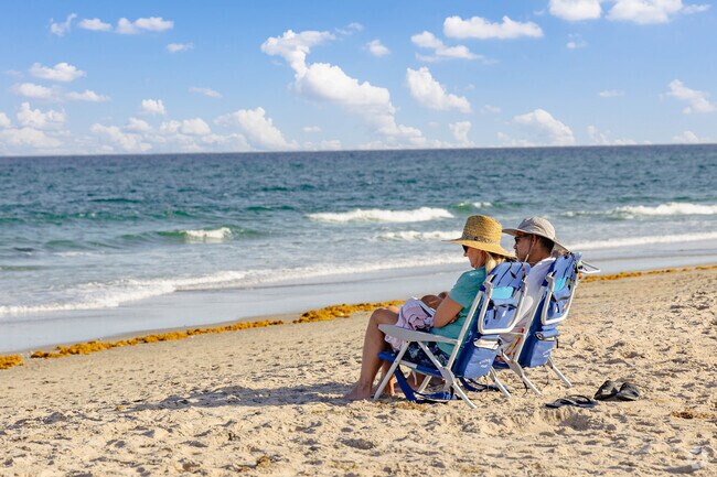 A couple savors the beach views in Delray Beach's serene setting.