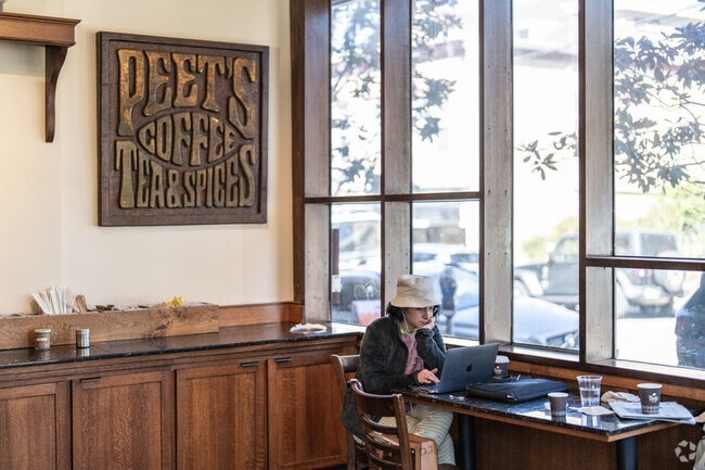A lady enjoys her morning coffee at the Original Peet's Coffee in North Berkeley.