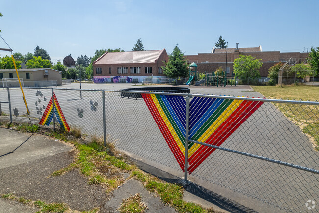Brightly colored on the fence around the playground at Cesar Chavez K-8 School.