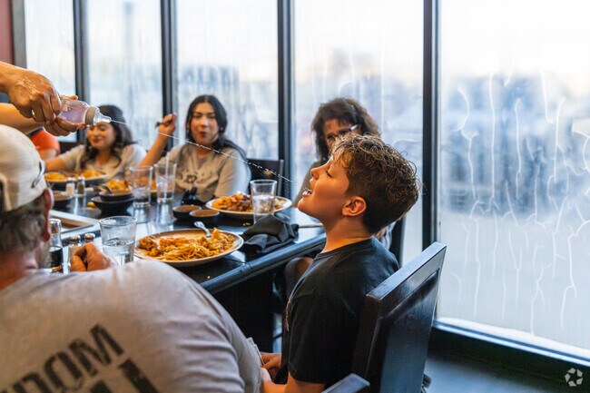 A chef squirts water into a guest's mouth at Kobe Japanese Steakhouse near West End.