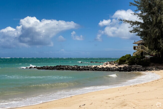 Visitors can take in views of beach and turquoise blue water at Kanaha Beach Park in Kahului.