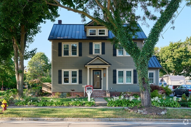 A Little Free Library in front of this Hilton Colonial home encourages neighbors to share books.