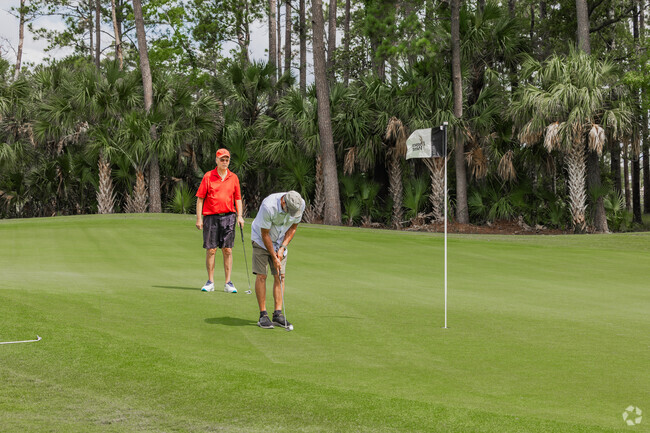 Dnes West residents enjoy playing golf with friends at Dunes West Golf Club.