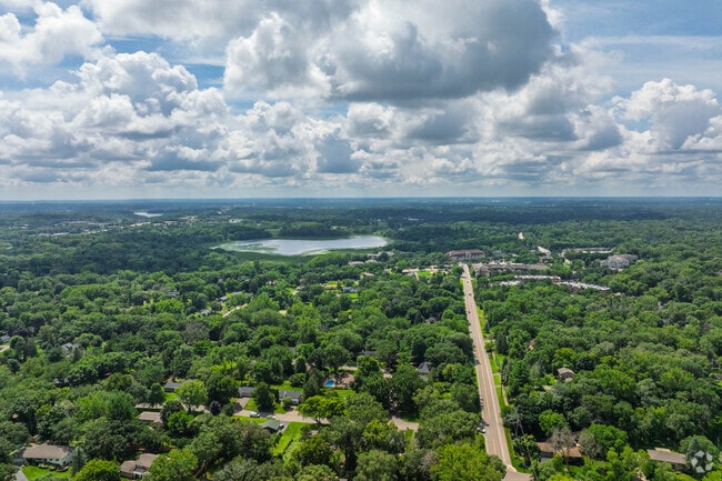 Glen Lake features raised ranch homes built on hills alongside traditional ranch designs, all surrounded by tall, thick trees that provide natural privacy and scenic beauty.