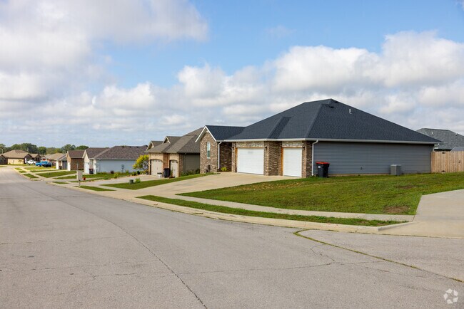 Suburban homes line this quiet Clever street, each with driveways and private yards.