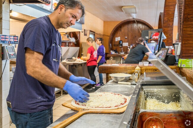 Find a delicious pie made by passionate workers at Naples Pizza in Valley View.