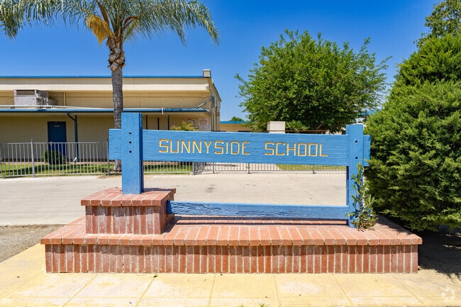 An old sign outside Sunnyside Elementary School welcomes students and parents.
