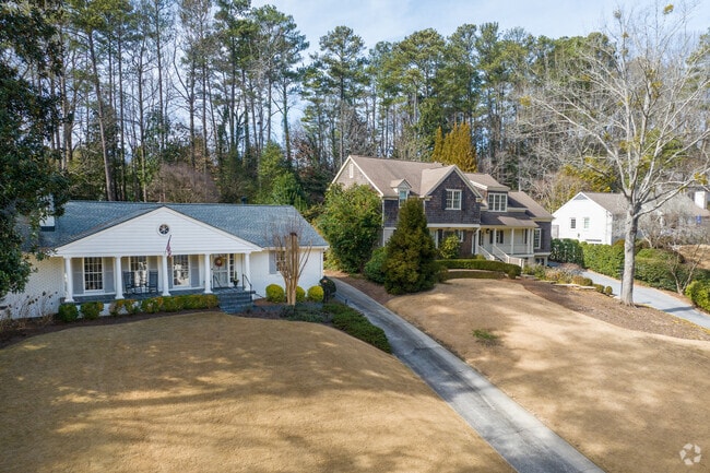 A row of homes sits back on lots with wooded backyards in Castlewood.