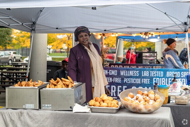 A vendor at Hunter Farmer’s Market greets locals with a smile.