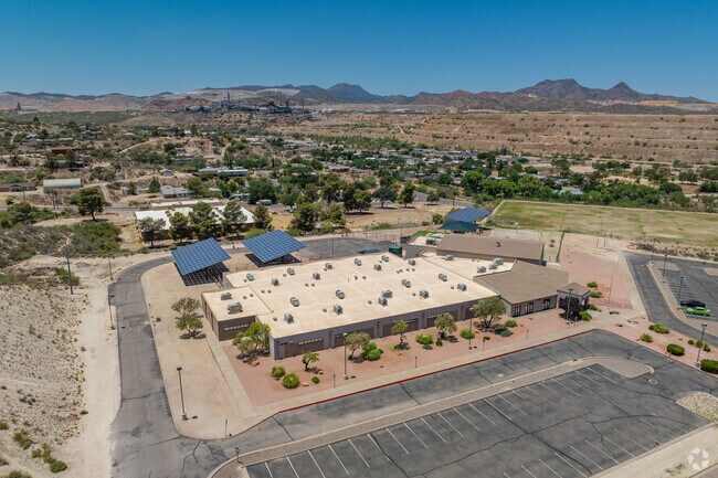 Dr. Charles A. Bejarano Elementary School features a sprawling single-story campus with desert landscaping and shaded entry areas.