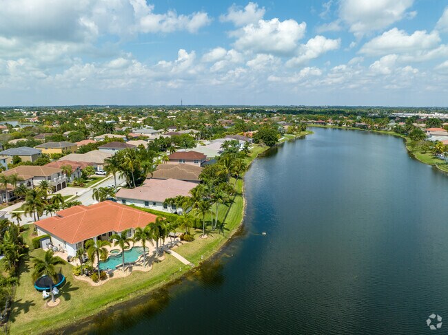 Waterfront Mediterranean-style houses with pools by the lake in Pembroke Shores.