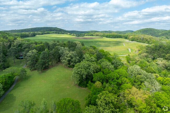 An aerial view of the Ouachita Mountains near Malvern, where rolling peaks stretch across the horizon.Stacks of freshly made bricks at Acme Brick Company in Malvern, showcasing the city's industrial roots.