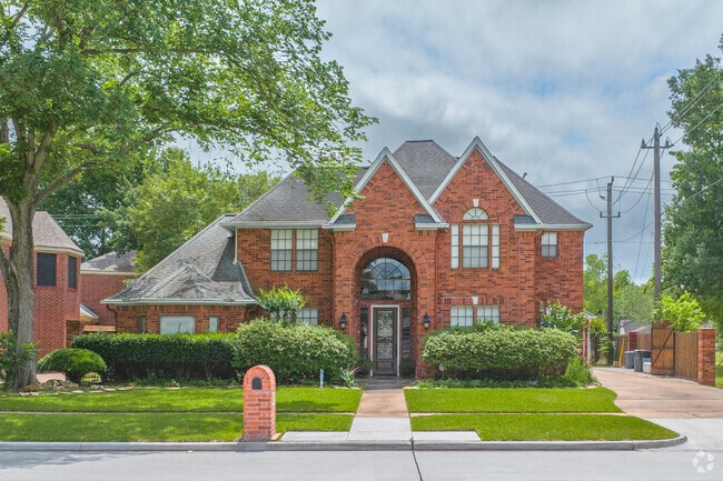 Cross‑gabled rooflines are common across Jersey Village homes.