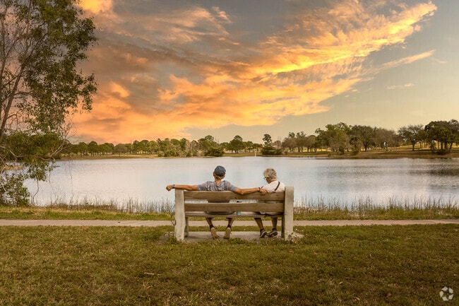 A couple relaxes and watch the sun set at Okeeheelee Park, five minutes from Olympia.