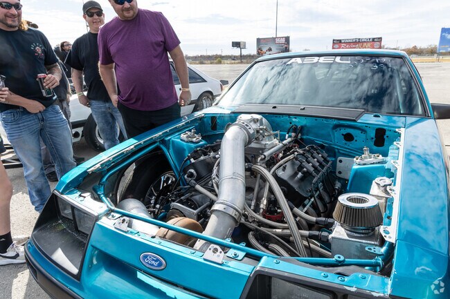 Drivers, crew and fans alike marvel at the fine-tuned machines in the pit at Tulsa Raceway Park