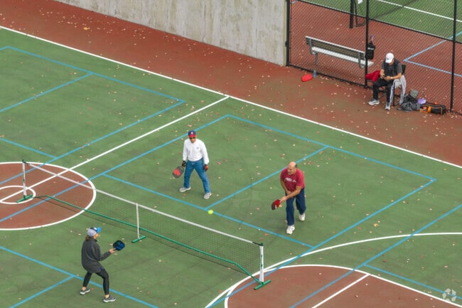 Residents in Rosedale play pickleball at Sehmel Homestead Park.