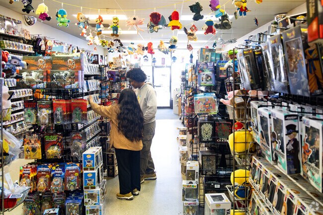 Customers browse the eclectic selection at Bella Comic Books and Toys near Lake Christopher.
