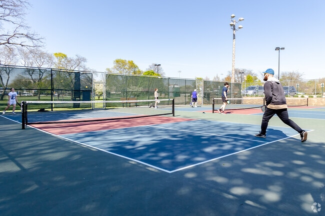 Residents are enjoying pickle ball match during a warm and sunny day.