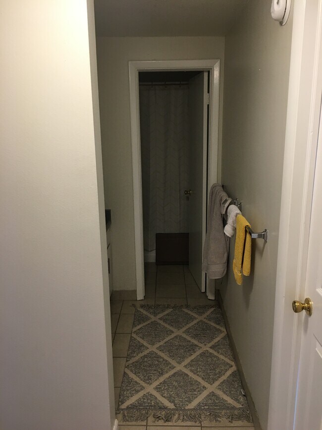 Upstairs bath includes double vanity, door to toilet, shower/tub combo
