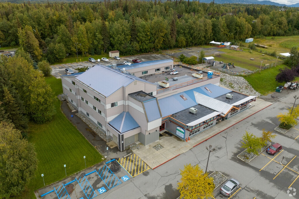 Pacific Northern Academy is on the corner of a commercialized area of Abbott Loop, AK.