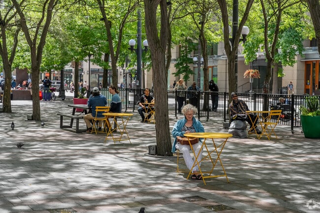 Locals relax in the shade near Westlake Center on warm days in Downtown Seattle.