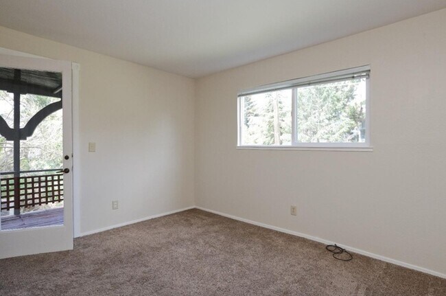 Back bedroom with a door to the side deck