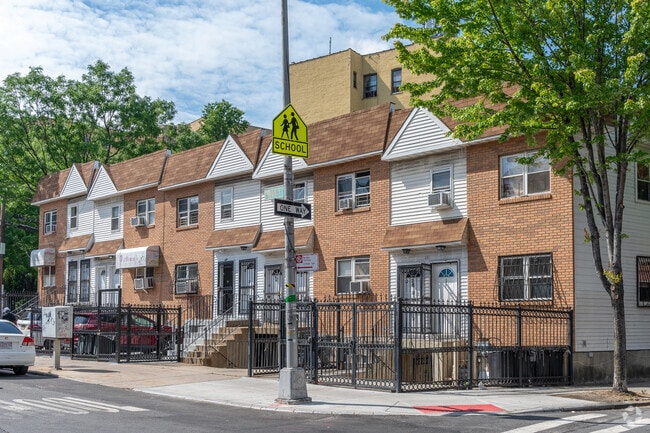 These brick townhouses in Highbridge feature dedicated parking spots.