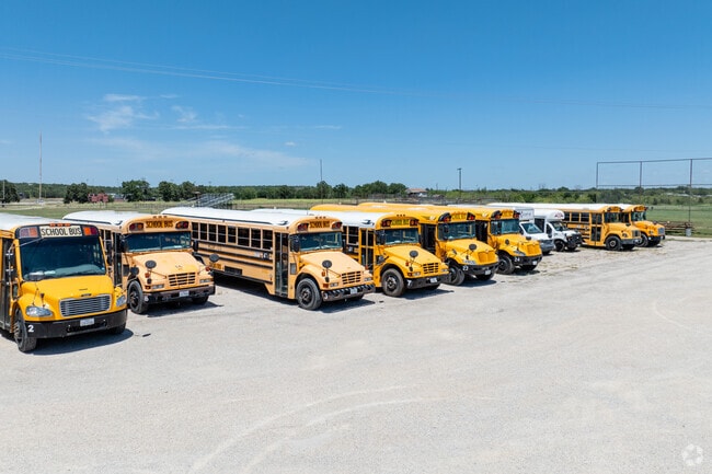 School buses stand ready at Millsap Middle School, offering transport for Bulldog students.